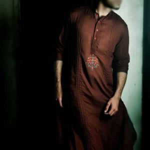 Trendy kurta shalwar for men in auburn color, embroidered motif and pleats on kurta front