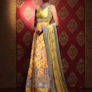 Glamorous Pakistani bridal gown dress in yellow-orange and gold color. Deep V-neck embellished bodice front slit fully embellished wedding gown comes with embellished bridal lehenga and bridal veils