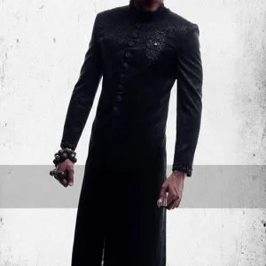 Jamawar sherwani for men in black colour, embroidery on sleeves cuff, motif and buttons detail on sherwani front
