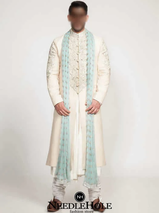Raw silk wedding sherwani for men in cream color with embellished collar, front, and sleeves