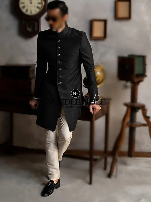 Groom black sherwani in raw silk fabric with antique sherwani buttons will give you a truly individual look on your big day