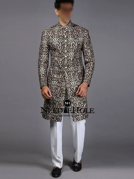 Capture the attention of your wedding guests by wearing this heavy embellished black sherwani for groom in raw silk fabric