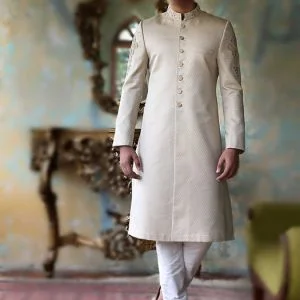 Jamawar groom sherwani for men wedding in ivory color and with gold buttons, comes with kurta pajama in offwhite color